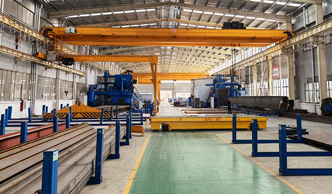 Overhead and gantry cranes transporting steel components between different production zones