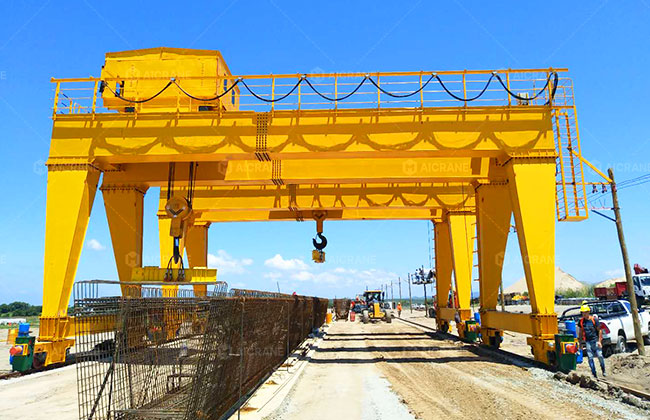 Gantry Crane Lifting Large Precast Concrete Beams in an Outdoor Precast Yard