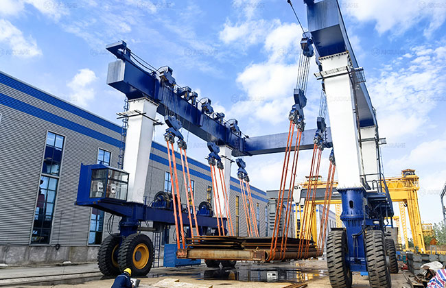 300 ton travel lift lifting steel plates in industrial yard operation