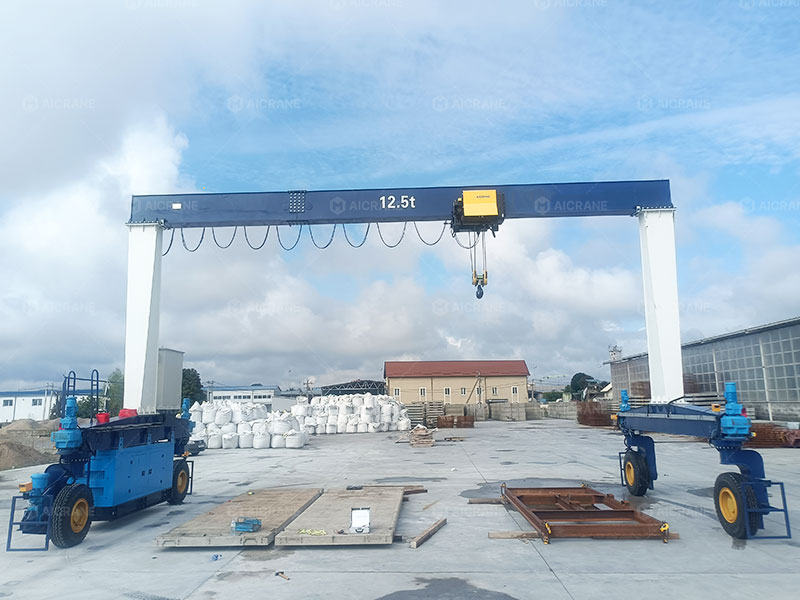 Lightweight RTG crane handling precast concrete in outdoor yard