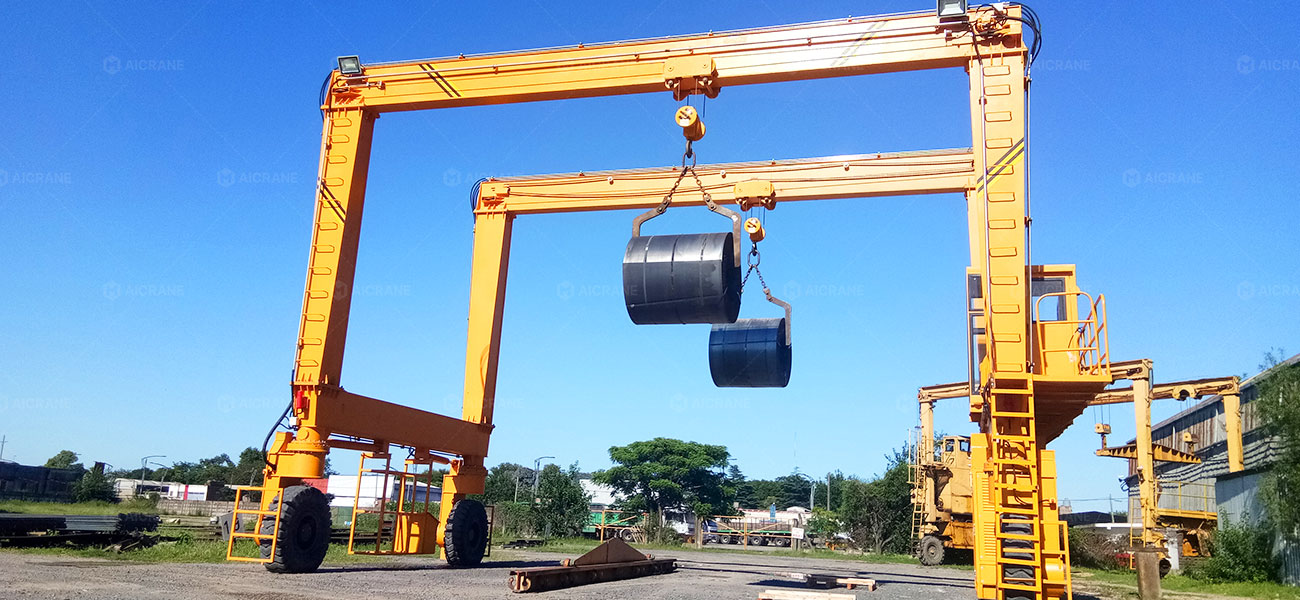 RTG crane handling steel coils and heavy metal products in a steel yard