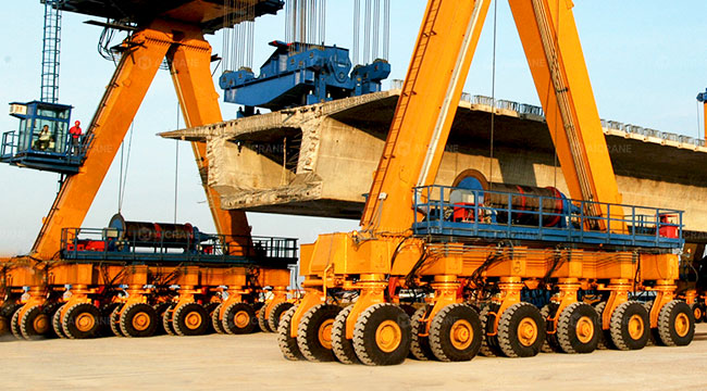 RTG crane positioning precast concrete components in a production yard