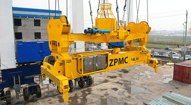 RTG crane spreader system handling ISO containers with twistlock engagement