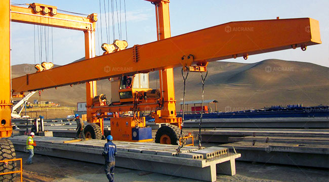 rubber tire crane with spreader beam and sling system for precast concrete elements