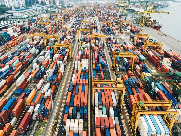 Container terminal yard with stacked containers and handling equipment supporting efficient container flow