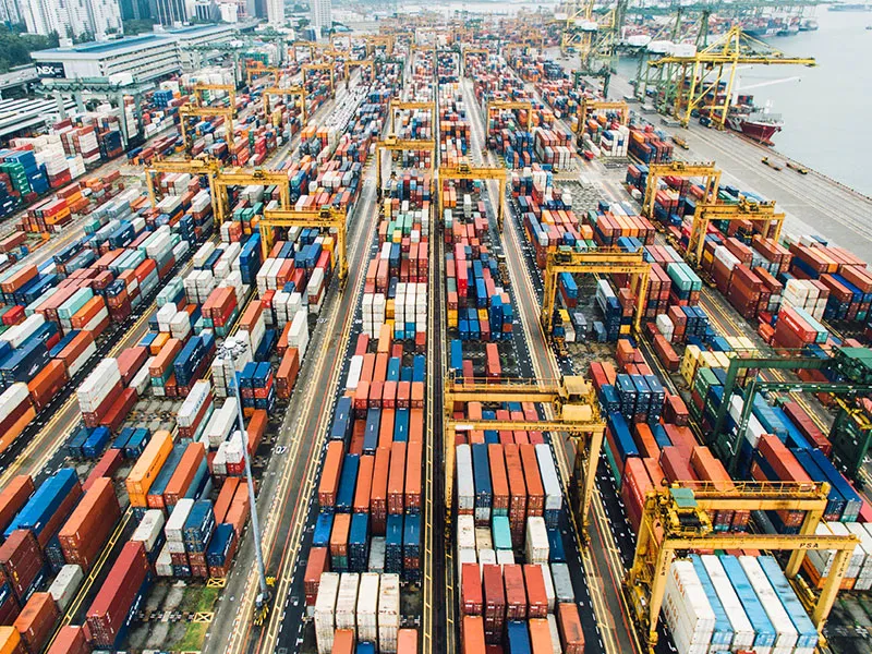 Container terminal yard with stacked containers and handling equipment supporting efficient container flow