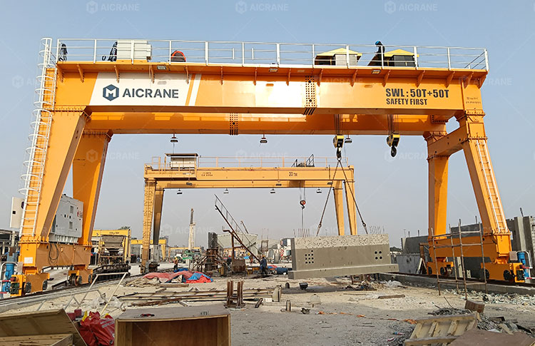 Double girder gantry crane handling large precast concrete components during production operations