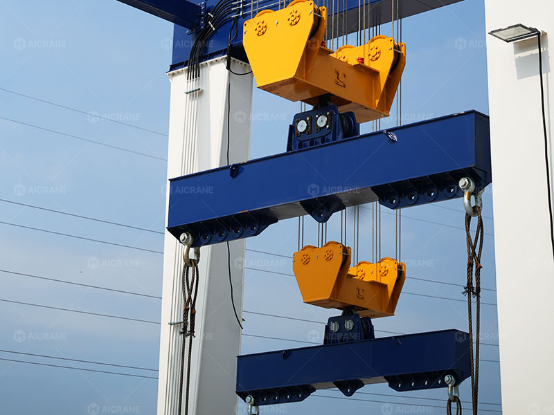 Dual hook lifting system with parallel spreader beams installed on a 120 ton rubber tyred gantry crane