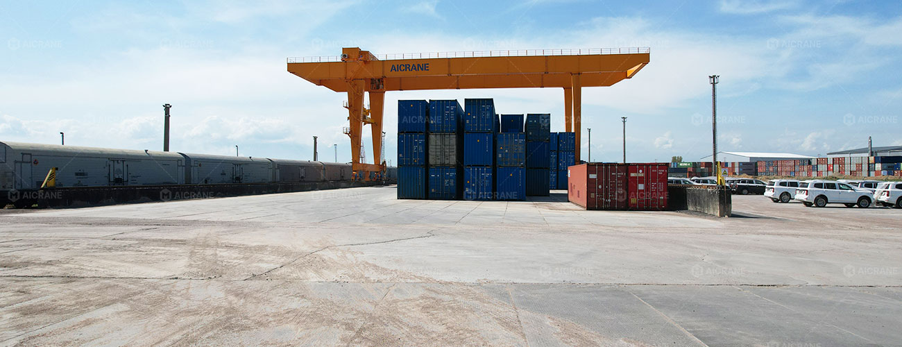 Intermodal rail terminal with container trains, rail tracks, and container handling equipment
