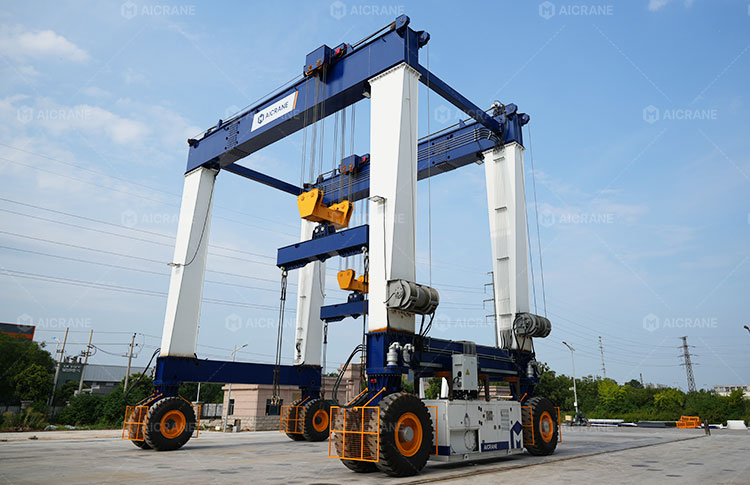 Rubber tyred gantry crane transferring materials between fabrication and assembly areas in a shipyard