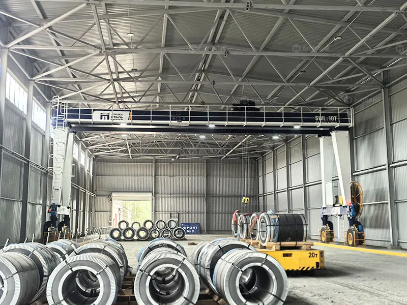 MGT 10 ton rubber tyred gantry crane loading steel coils onto electric transfer carts