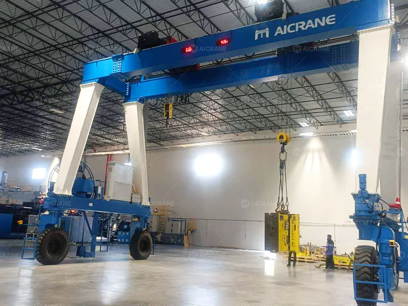 MGT 32/20 ton rubber tyred gantry crane transporting automotive injection molds inside a warehouse