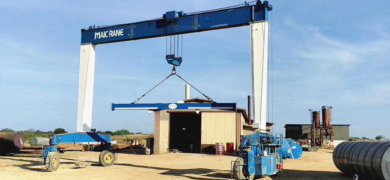 YTL 40T hydraulic rubber tyred gantry crane handling large steel tanks in a manufacturing yard in the US